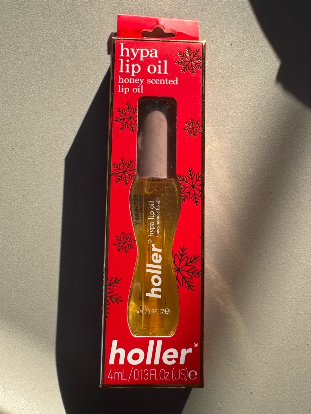 Holler and Glow Hypa Lip Oil in the honey scent